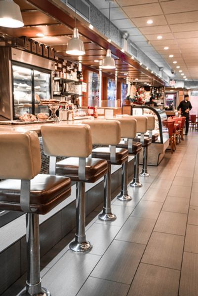 A diner with a row of stools and a counter