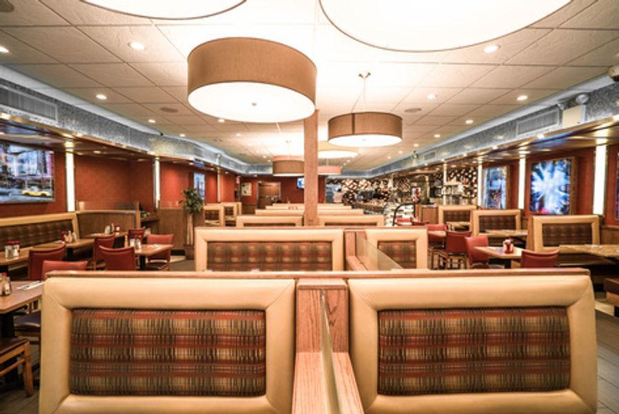 A restaurant with a lot of booths and tables