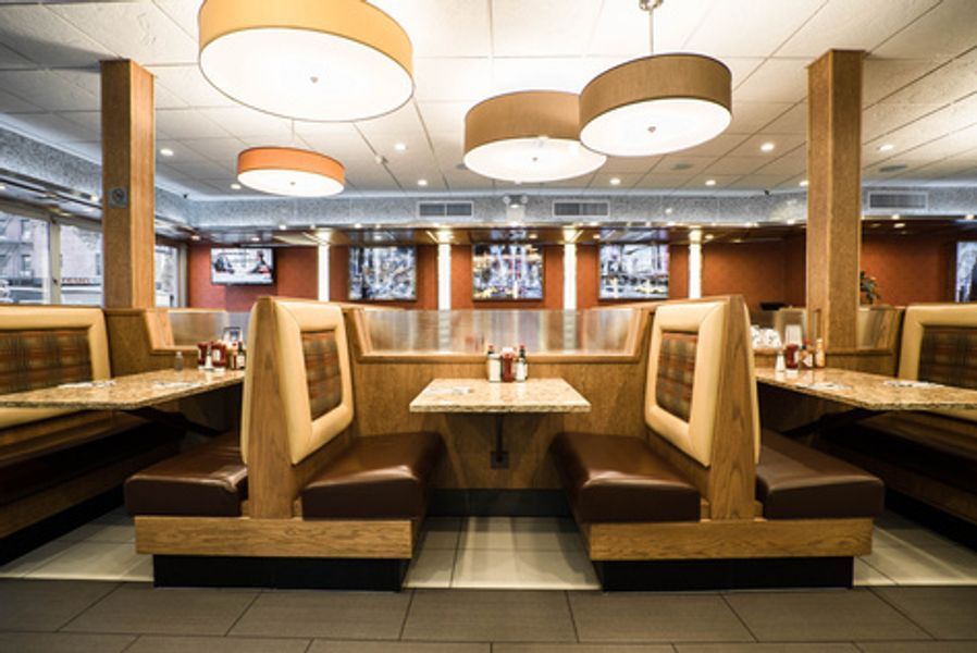 A restaurant with a lot of booths and tables