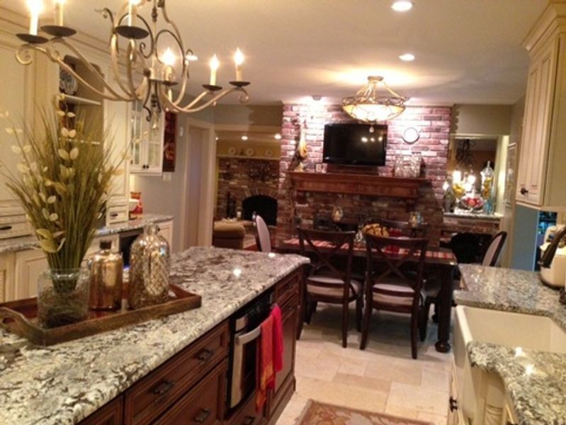 A kitchen with granite counter tops and a fireplace