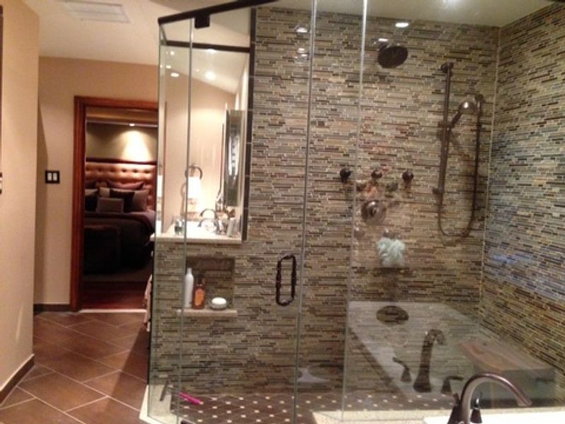 A bathroom with a walk in shower and a bathtub