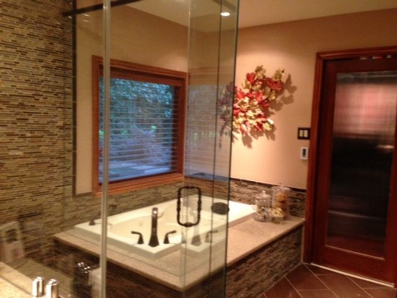 A bathroom with a bathtub and a window