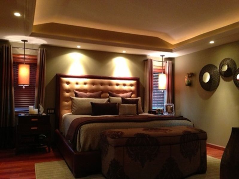 A bedroom with a large bed and ottoman