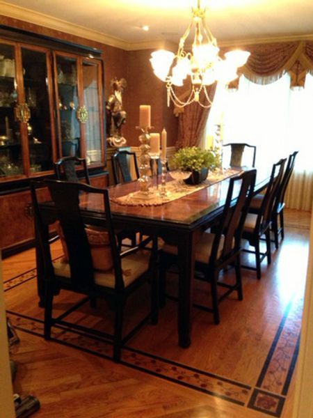 A dining room with a table and chairs and a chandelier