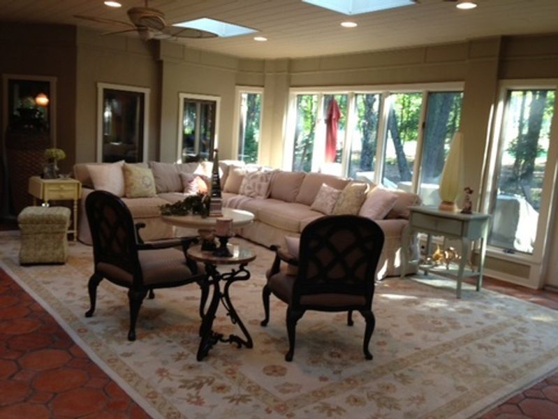 A living room with a couch and chairs and a table