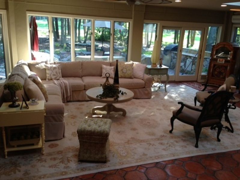A living room with a couch and chairs and a table