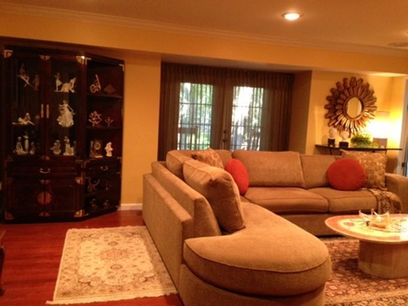 A living room with a large sectional couch and a coffee table