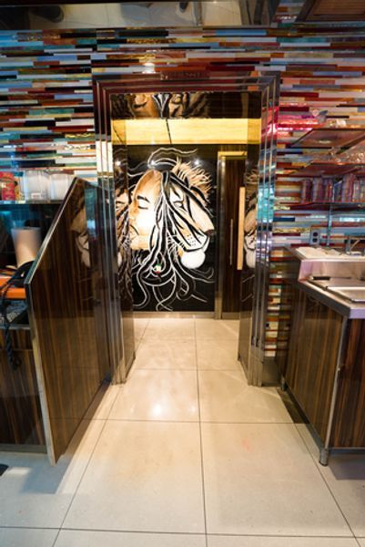 A hallway with a painting of a woman 's face on the wall