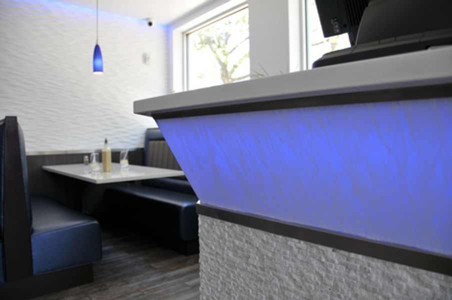 A restaurant with a blue light on the counter