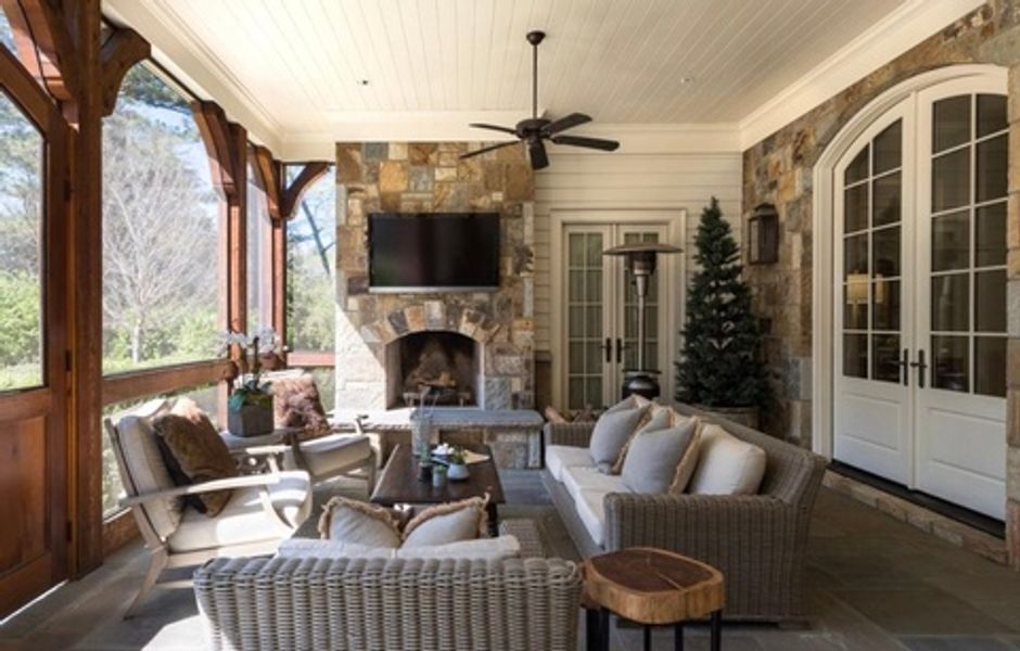 A living room with a couch, chairs, a fireplace and a television