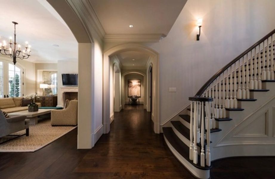 A hallway with stairs leading up to the second floor of a house