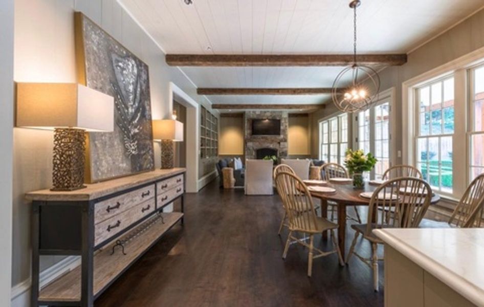 A living room with a table and chairs in it