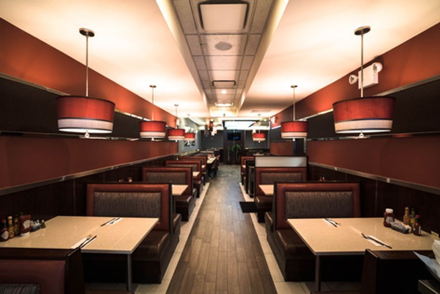 The inside of a diner with tables and booths