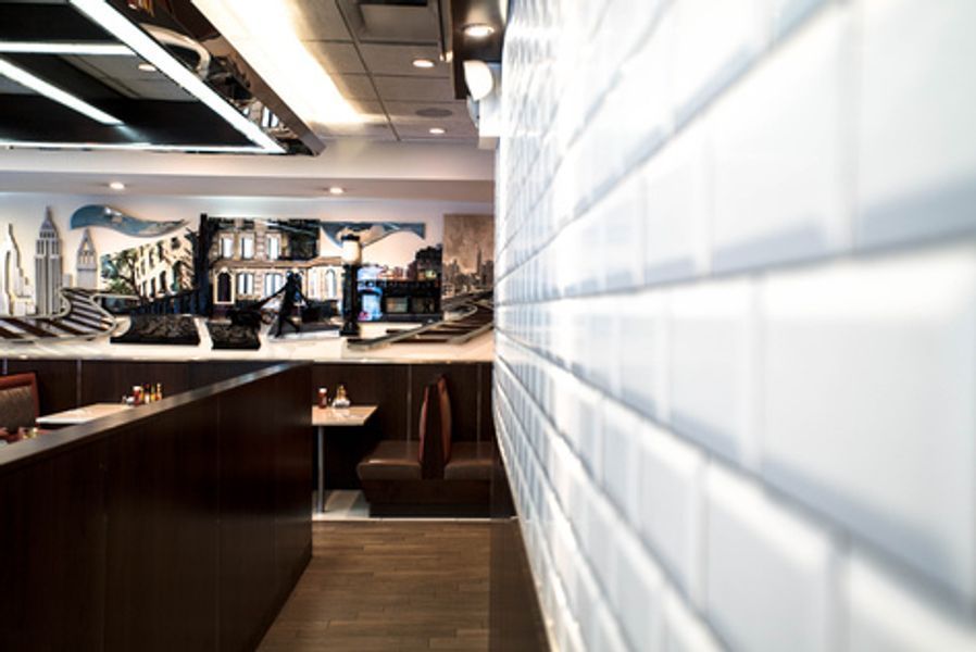 A restaurant with a brick wall and tables and chairs