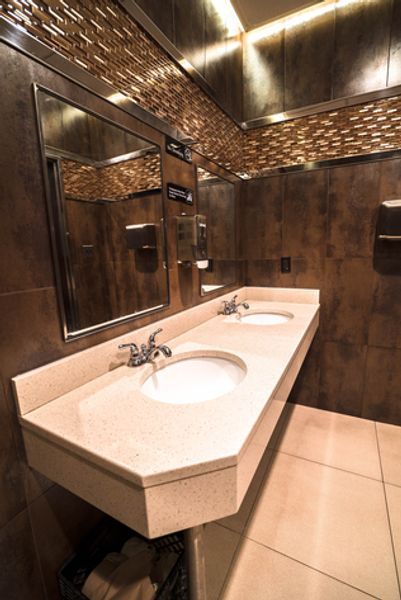A bathroom with two sinks and two mirrors