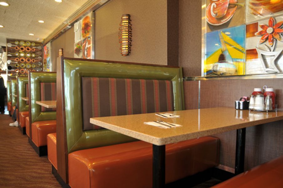 The inside of a diner with tables and booths