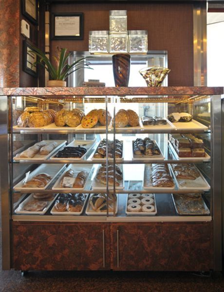 A display case filled with a variety of baked goods