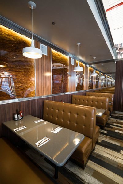 A diner with tables and benches lined up in a row