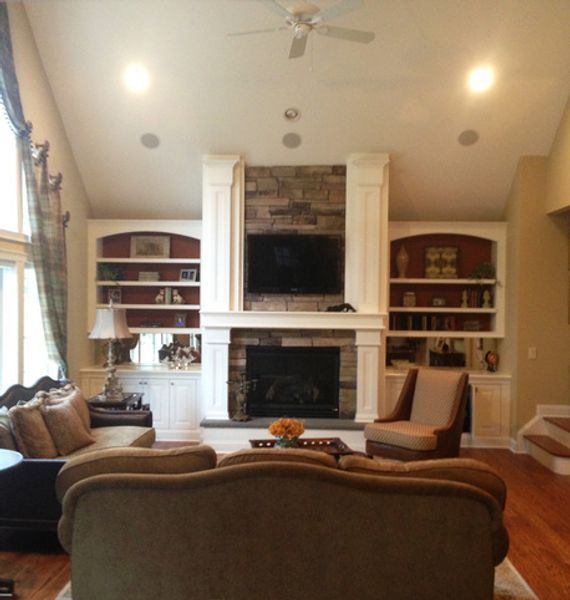 A living room with a fireplace and a flat screen tv