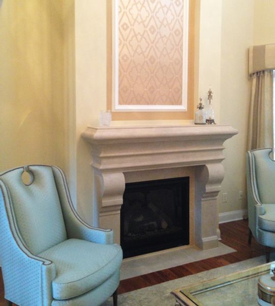 A living room with two chairs and a fireplace