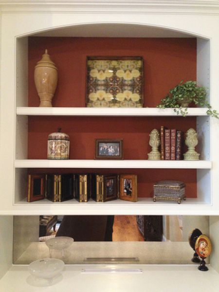 A shelf with a picture of a man on it