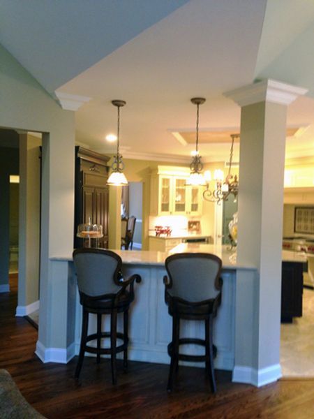 Two bar stools sit at a counter in a kitchen