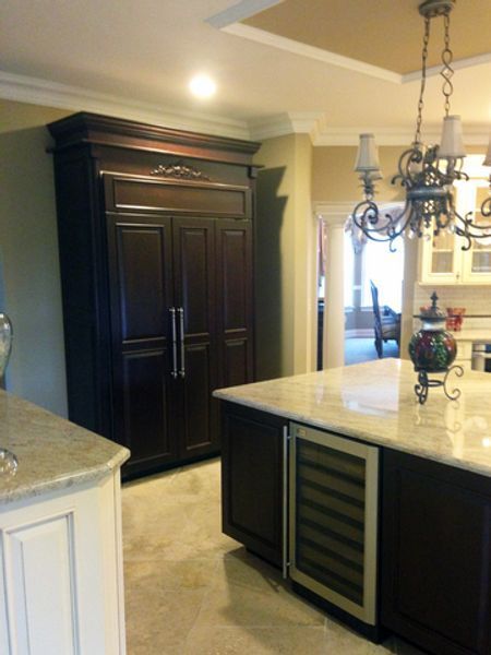 A kitchen with a large island and a refrigerator