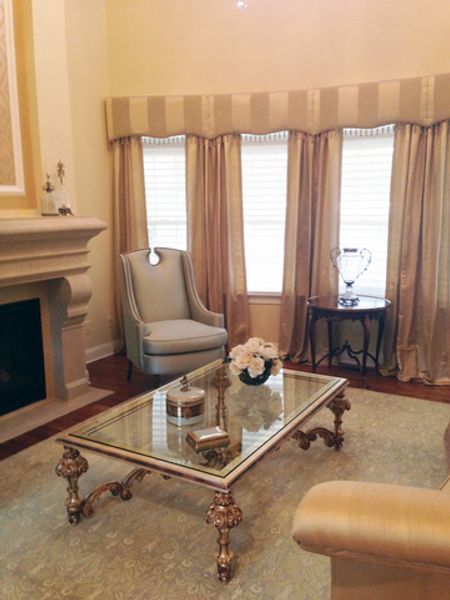 A living room with a fireplace and a glass coffee table