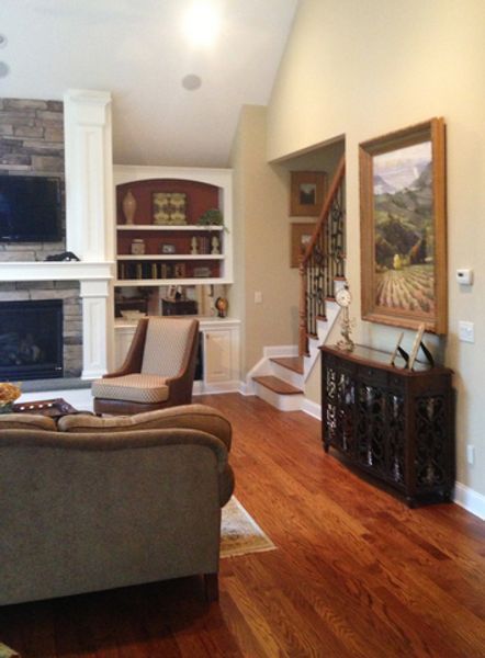 A living room with hardwood floors and a fireplace