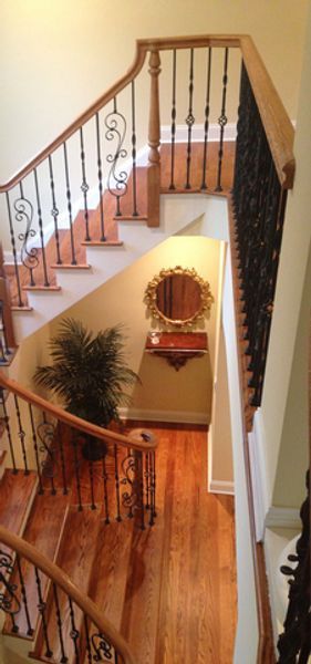 A view of a staircase from the second floor of a house