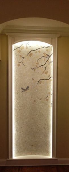 A door with a painting on it and a light behind it