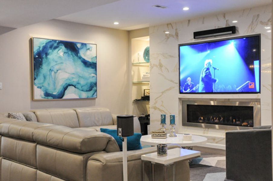 A living room with a couch, fireplace and television