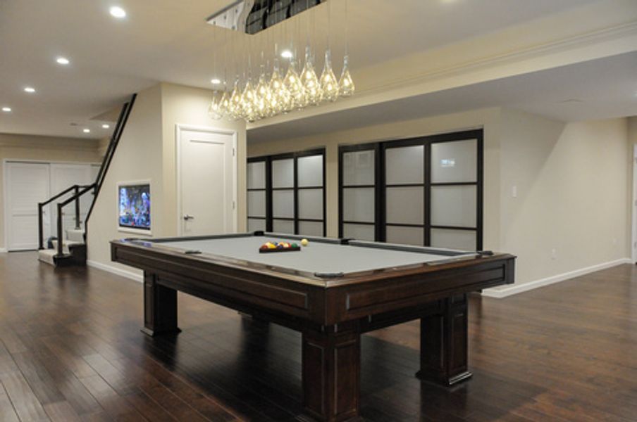 There is a pool table in the middle of the room