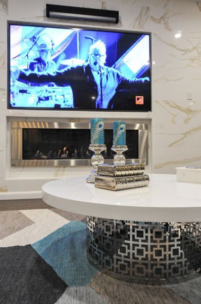 A living room with a fireplace and a flat screen tv