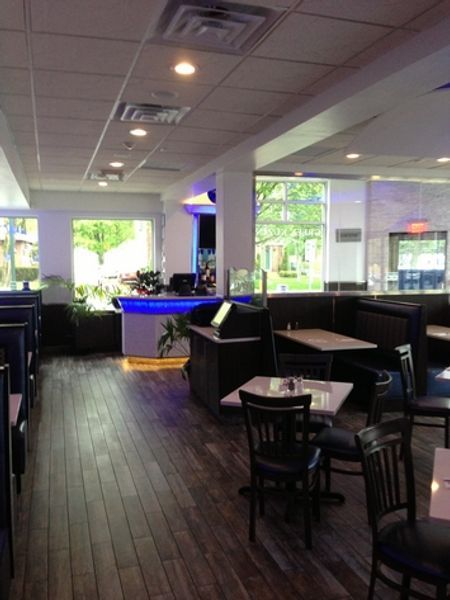 The inside of a restaurant with tables and chairs