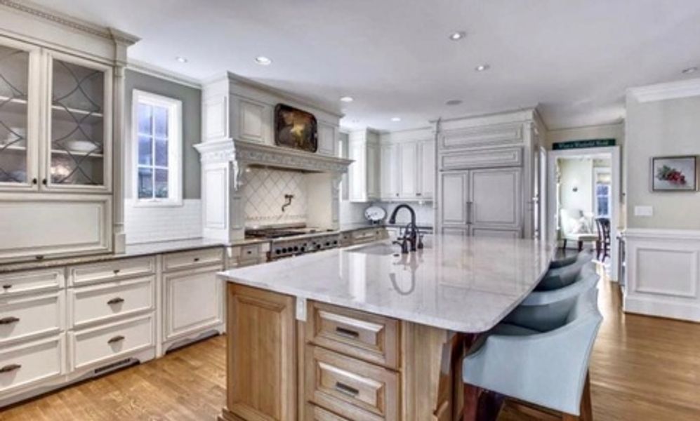 A large kitchen with a large island in the middle of it