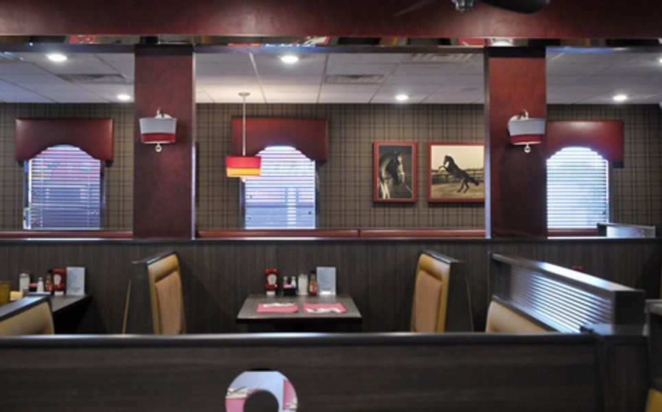 A diner with a horse painting on the wall