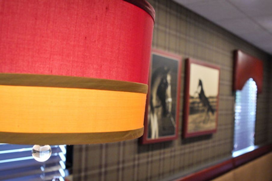 A red and yellow lamp hanging from the ceiling in a room