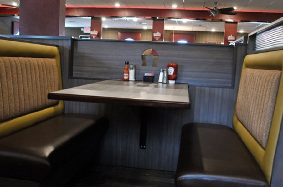A diner booth with a table and two benches