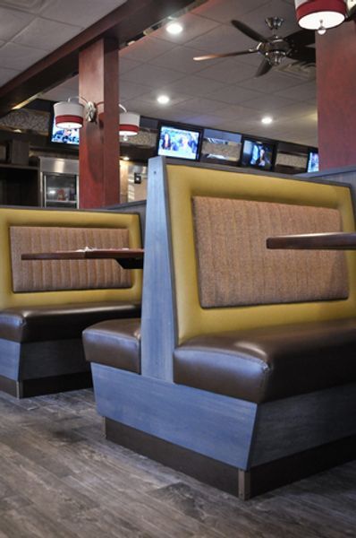 A row of booths with tables in a restaurant