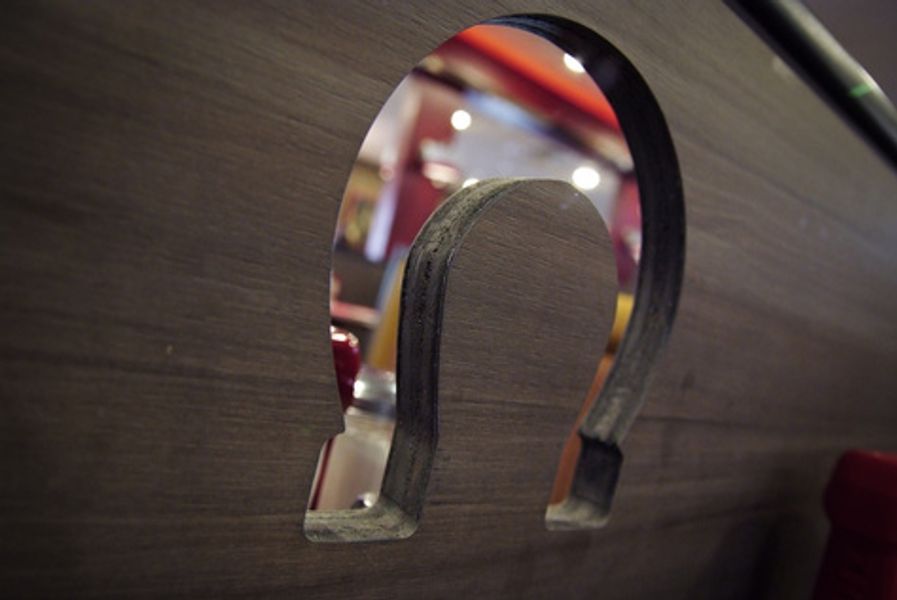 A horseshoe is carved into a piece of wood