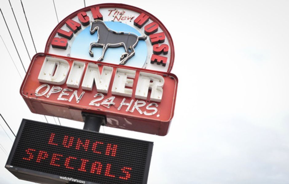 A sign for a diner that is open 24 hours