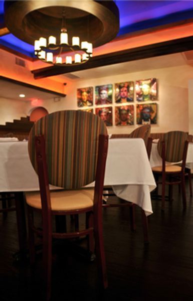 A restaurant with tables and chairs and a chandelier