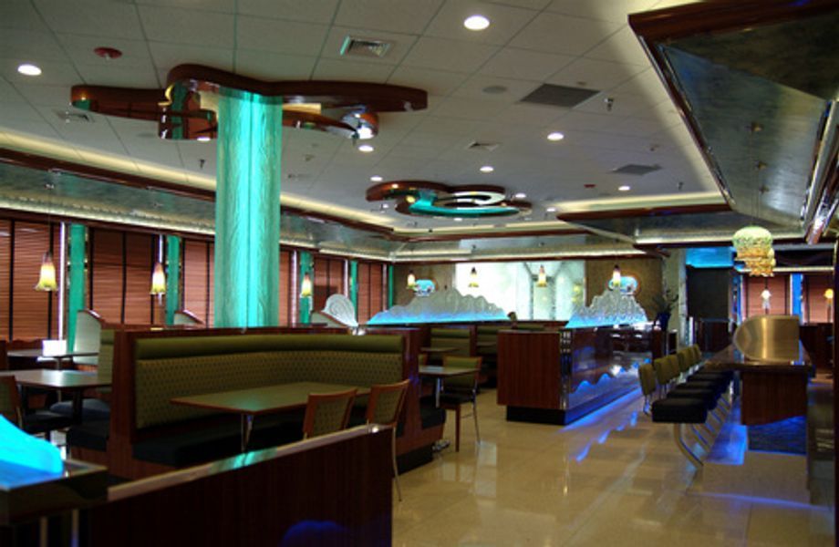 The inside of a restaurant with tables and chairs