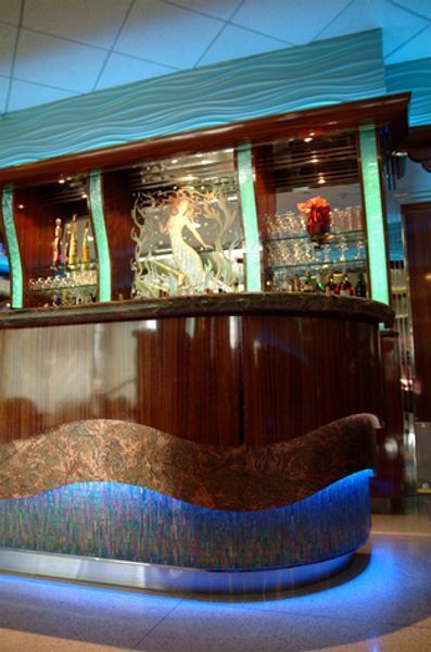 A bar with a statue of a mermaid on top of it
