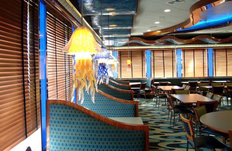 A restaurant with tables and chairs and a jellyfish lamp