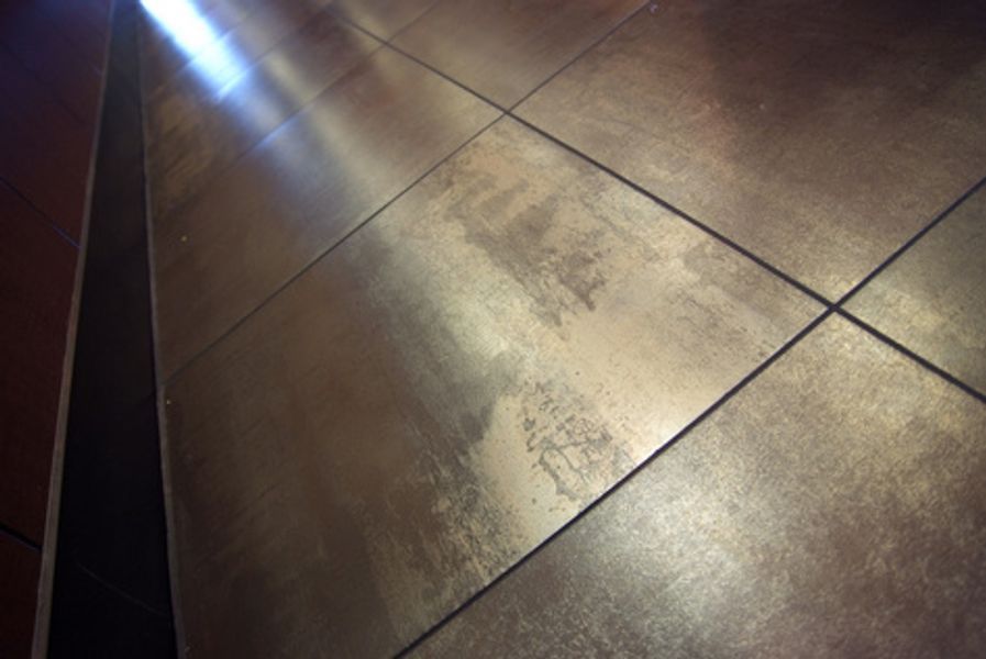 A close up of a tiled floor with a light shining through it