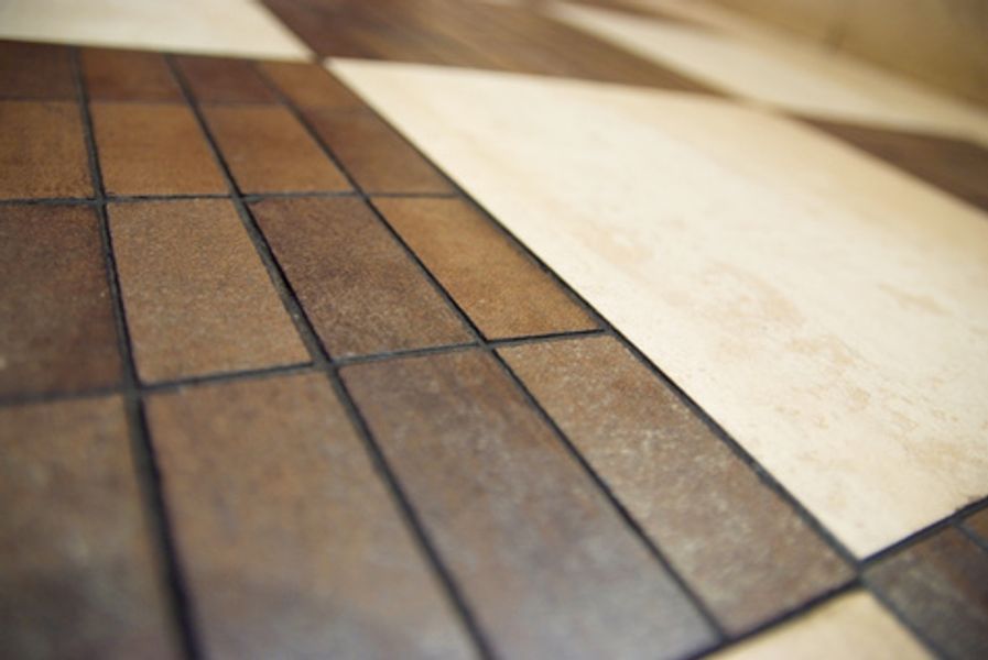 A close up of a tiled floor with a checkered pattern