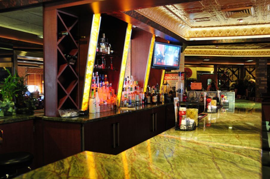 A large room with a bar and a television on the wall