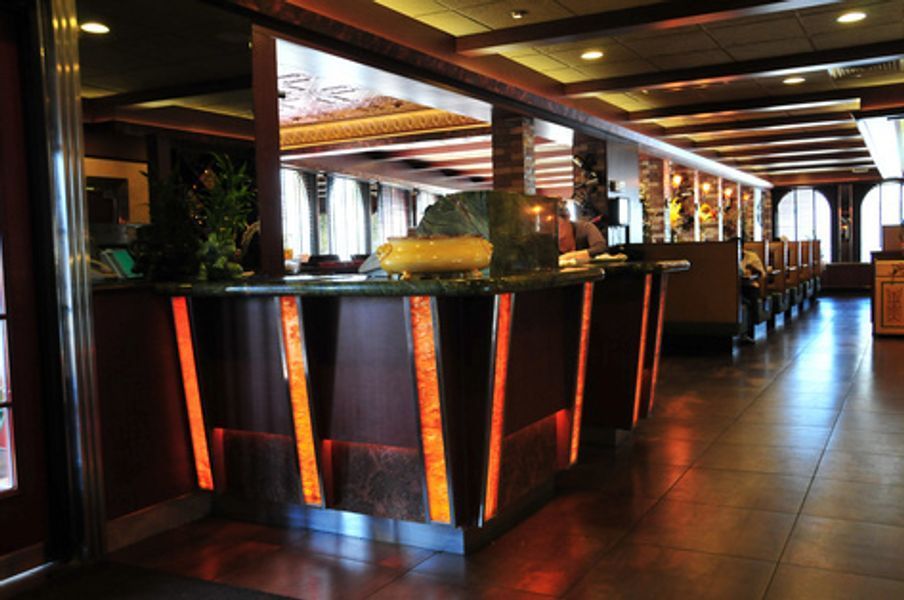 A long hallway with a counter in the middle of it